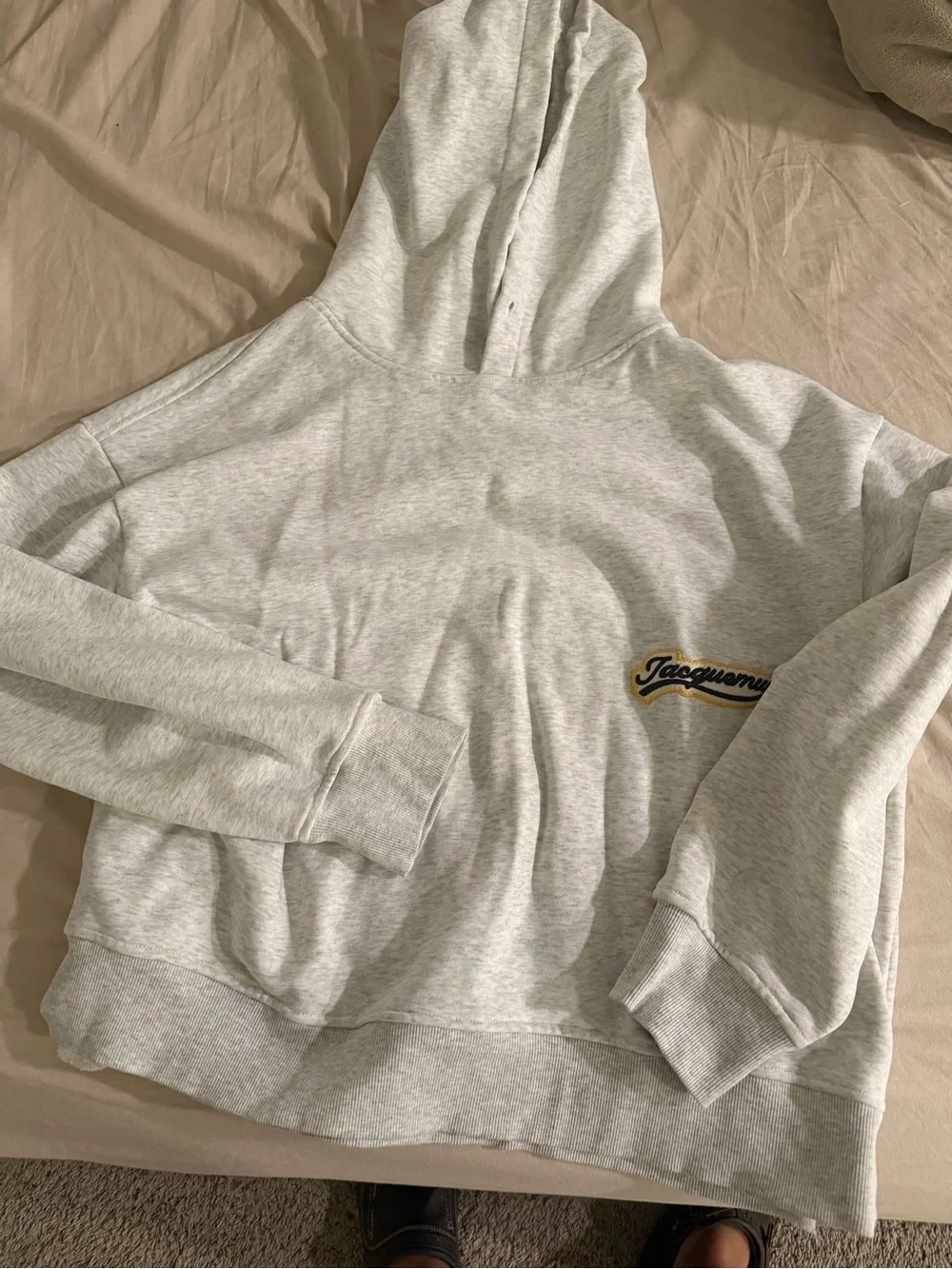 Jacquemus Light Gray Hoodie with Black and Yellow Logo